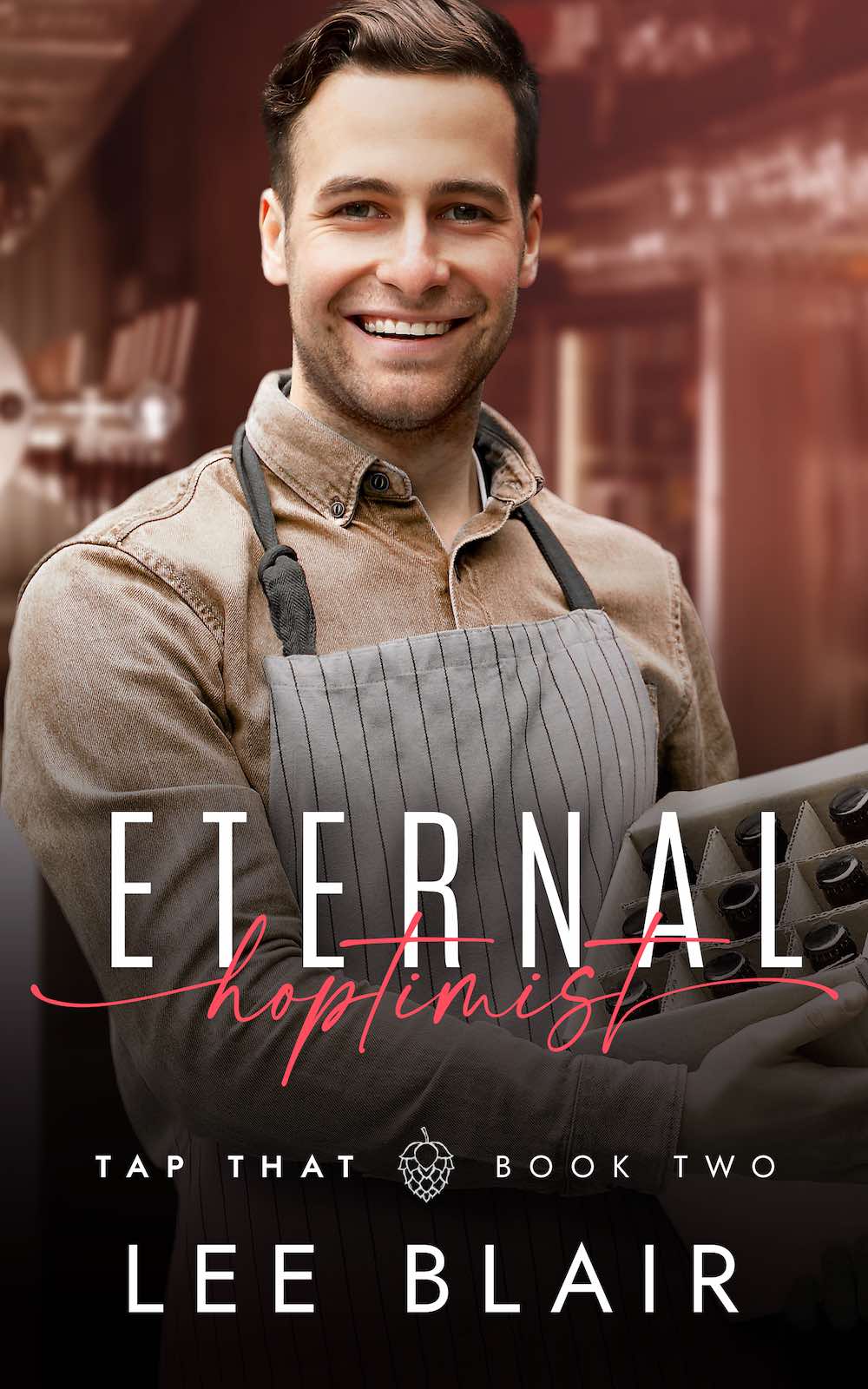 Eternal Hoptimist by Lee Blair. A smiling Caucasian man with light brown hair is wearing a beige shirt and apron and holding a box of beer bottles.